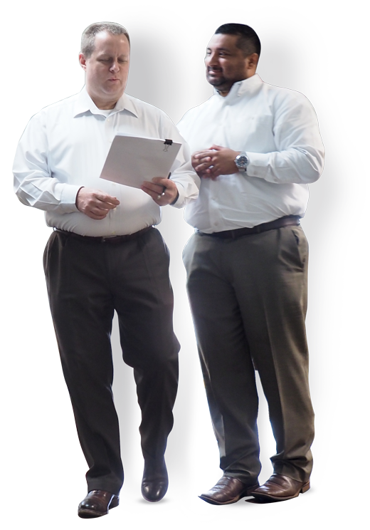 two men in white shirts professionals walking talking looking at paper financial group