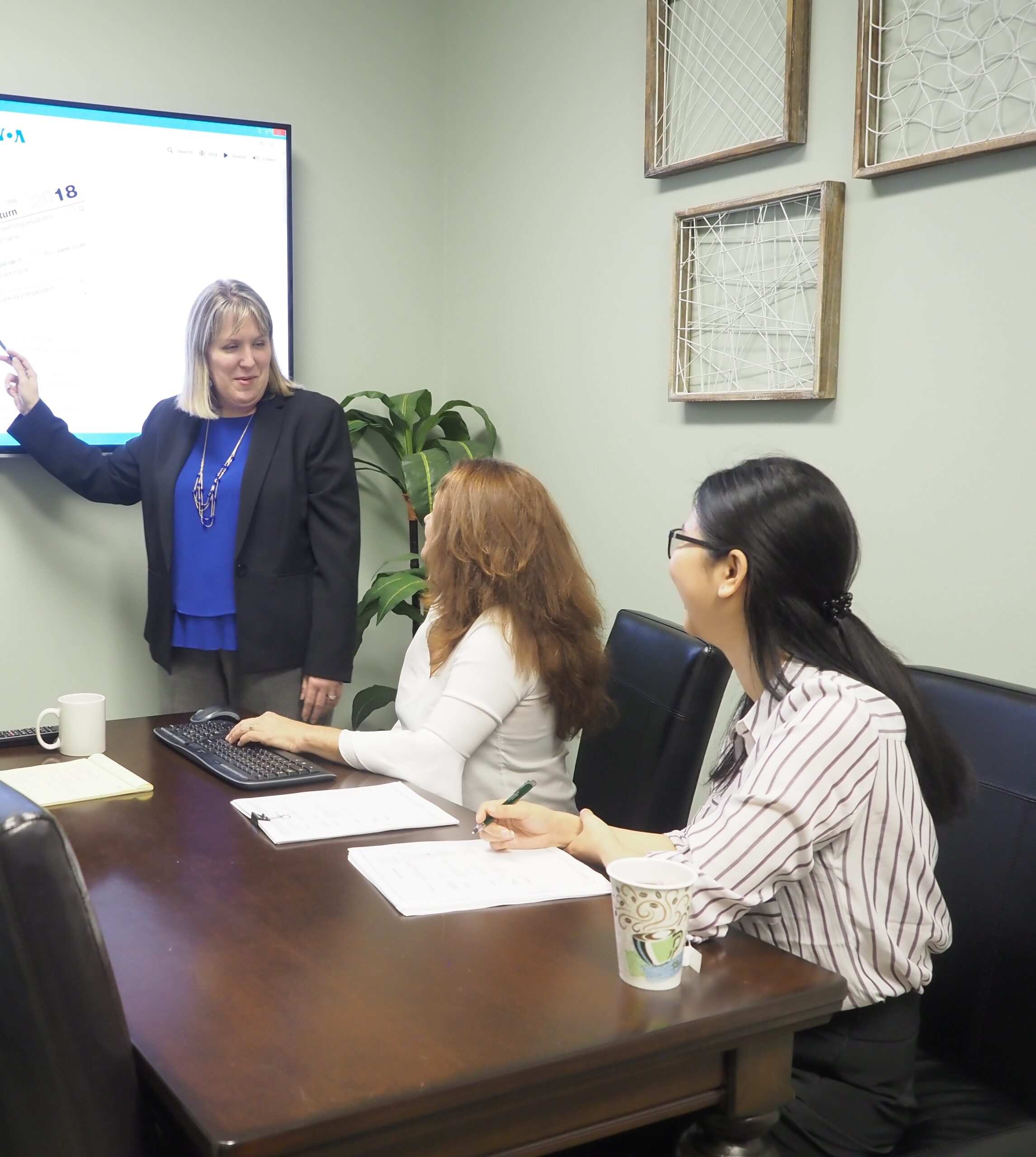 young professionals in tax accounting firm afairchild pc looking up at screen side view